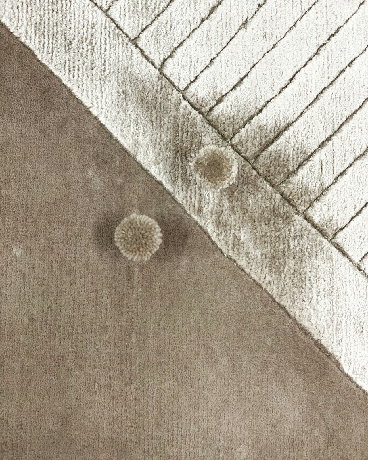 Close-up of two pile heights in taupe and ivory with matching colour poms