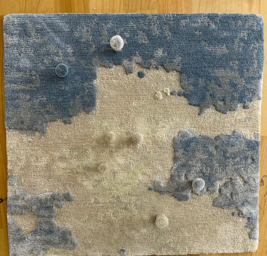 Square strike-off sample in ivory and blue with colour poms